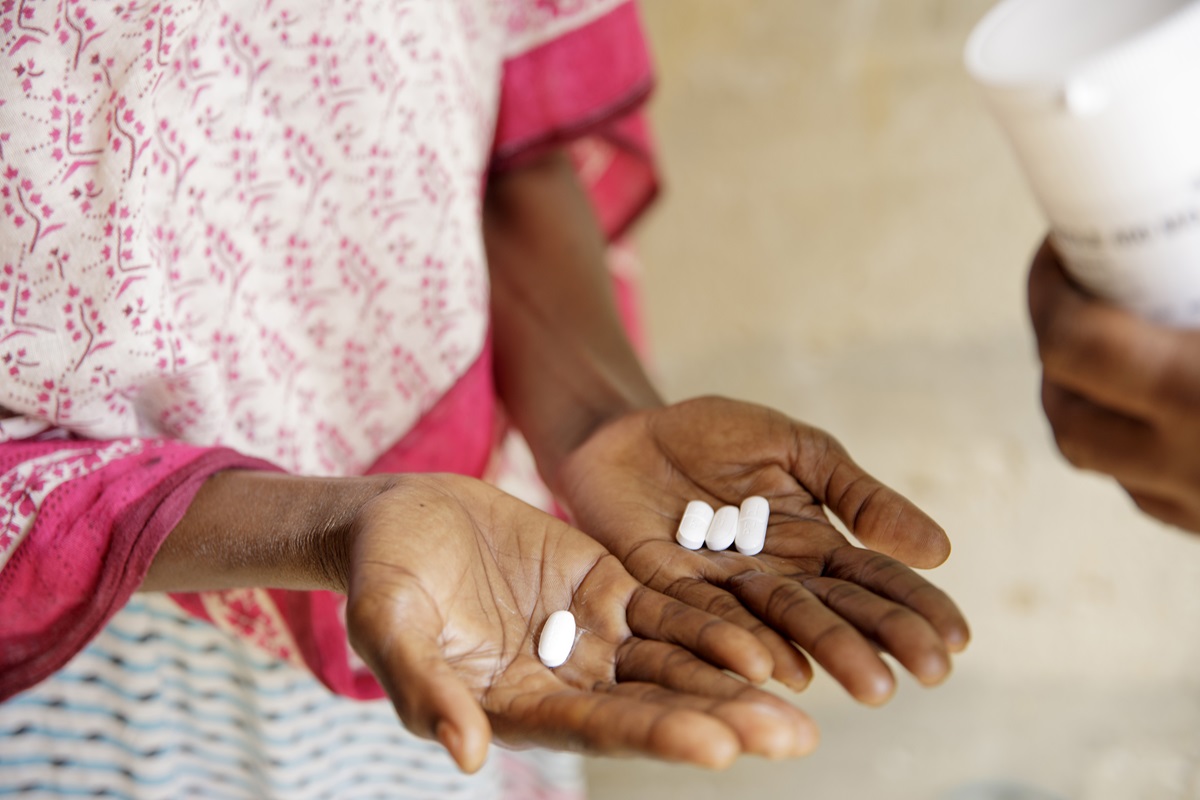 A woman holds out her hands showing the treatment used against schistosomiasis, Praziquantel, during a mass drug administration in Pemba, Zanzibar.