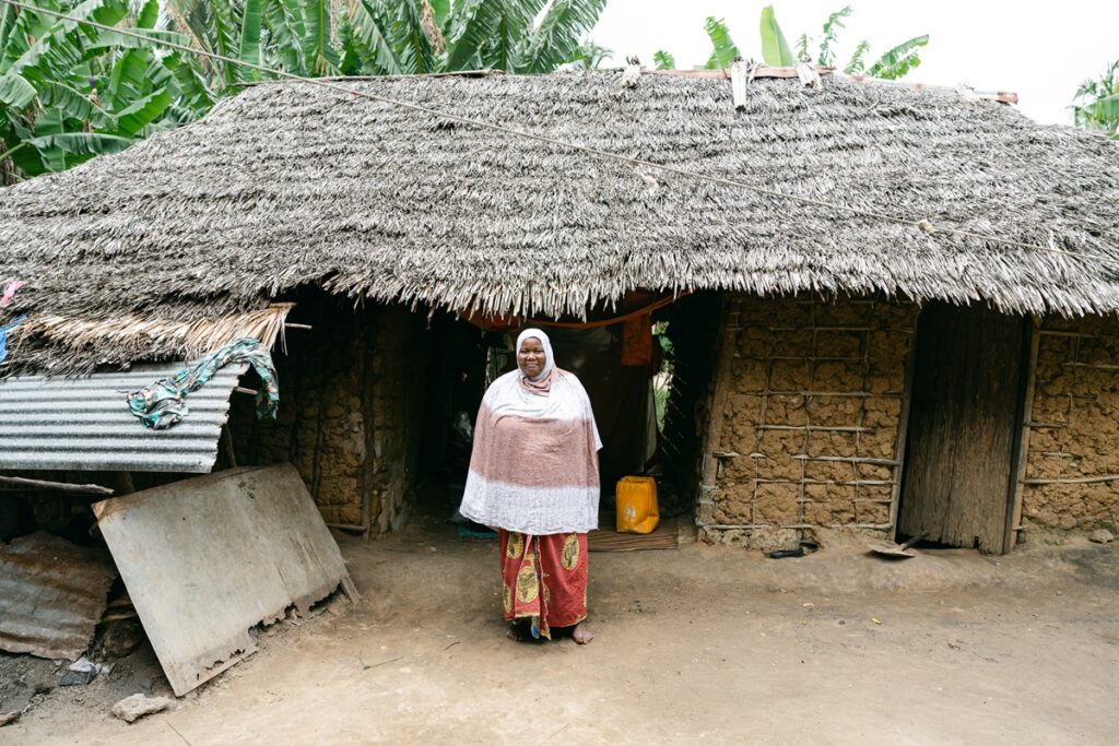 Mariam in front of her house.